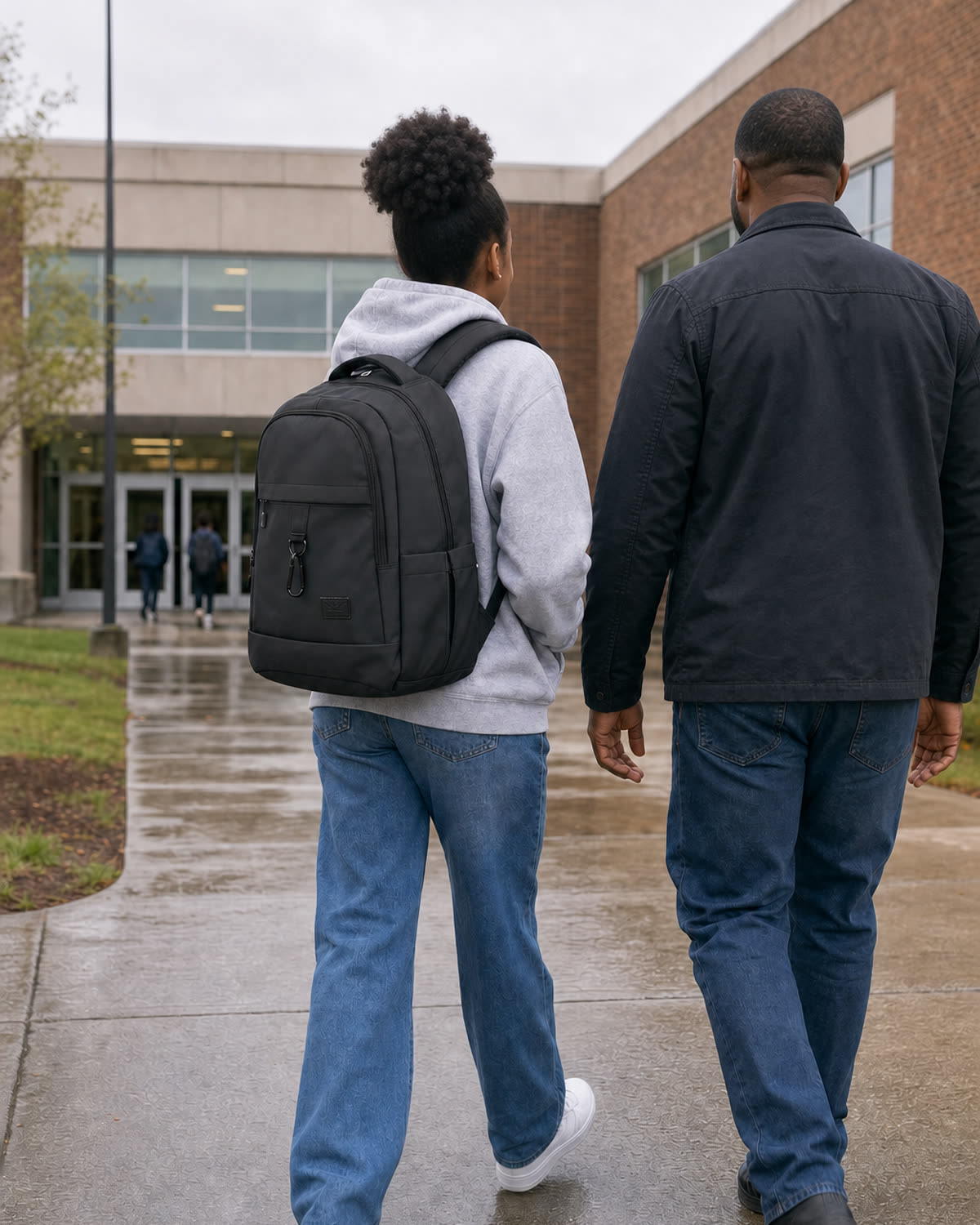 A parent and student walking to school, the student wearing the GA Backpack