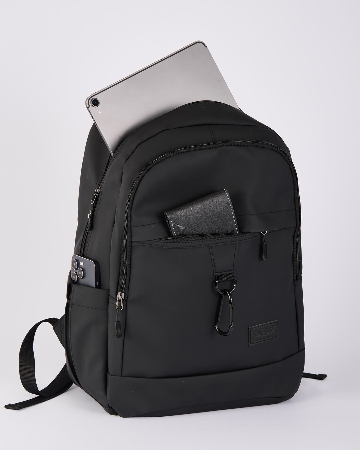 The everyday backpack with discreet protection built in., three-quarter view with a laptop in the rear sleeve